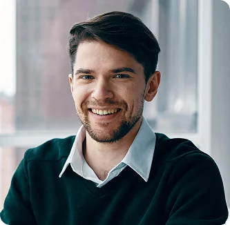 Creative Xionnix designer with curly red hair and headphones