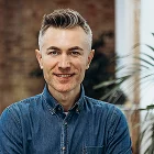 Man in a blue sweater, Xionnix WordPress development services